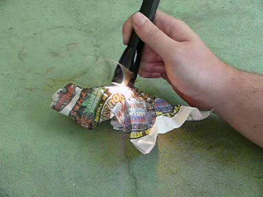 An Auroralite Minimag hotwire making holes in some newspaper
